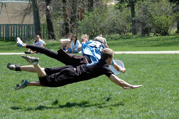 Ultimate players diving for a catch